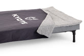 Kyote Dog Swag portable dog bed on its elevated frame with removable legs, grey sherpa fleece top and canvas sides